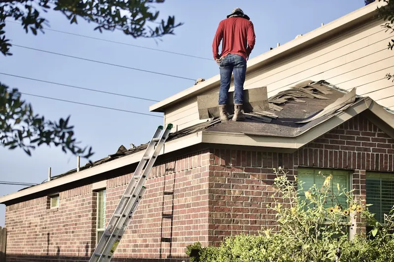 Professional roofer working on a residential roof in Oreana